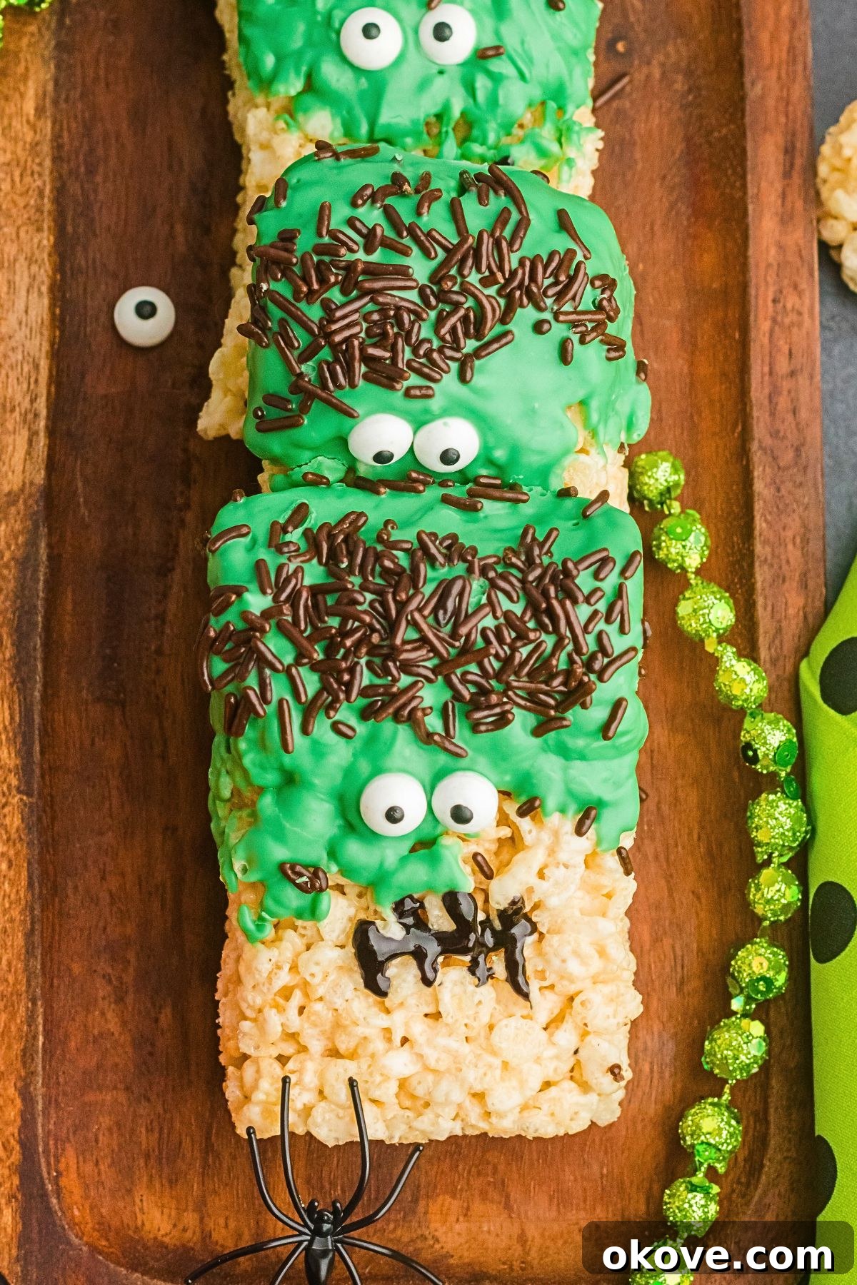 Monster Mash Krispies 2 Fun Halloween rice krispies treats in the shape of Frankenstein on a wooden board.