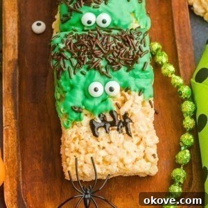 Monster Mash Krispies 10 Decorated Frankenstein rice krispies treats on a wooden board.