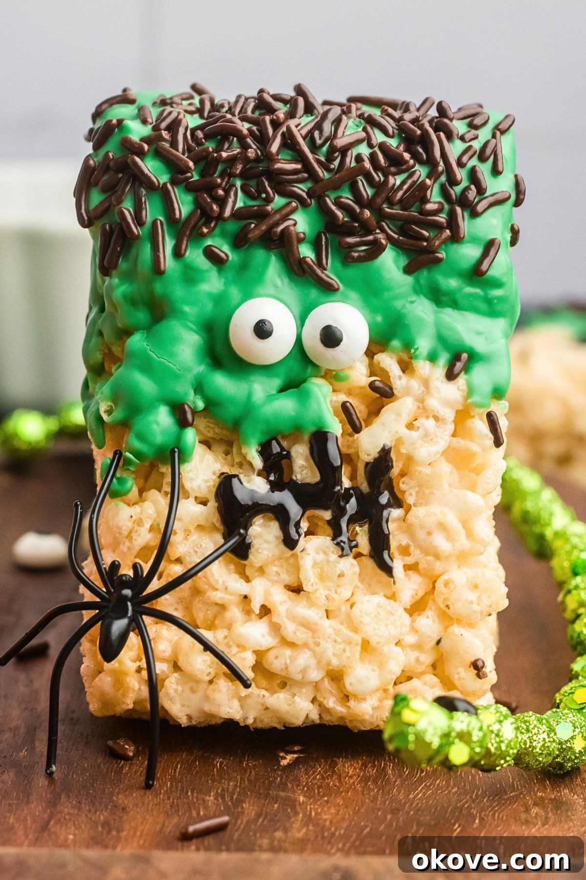 Monster Mash Krispies 9 close up of Rice krispie treat decorated to look like Frankenstein on a wooden board.