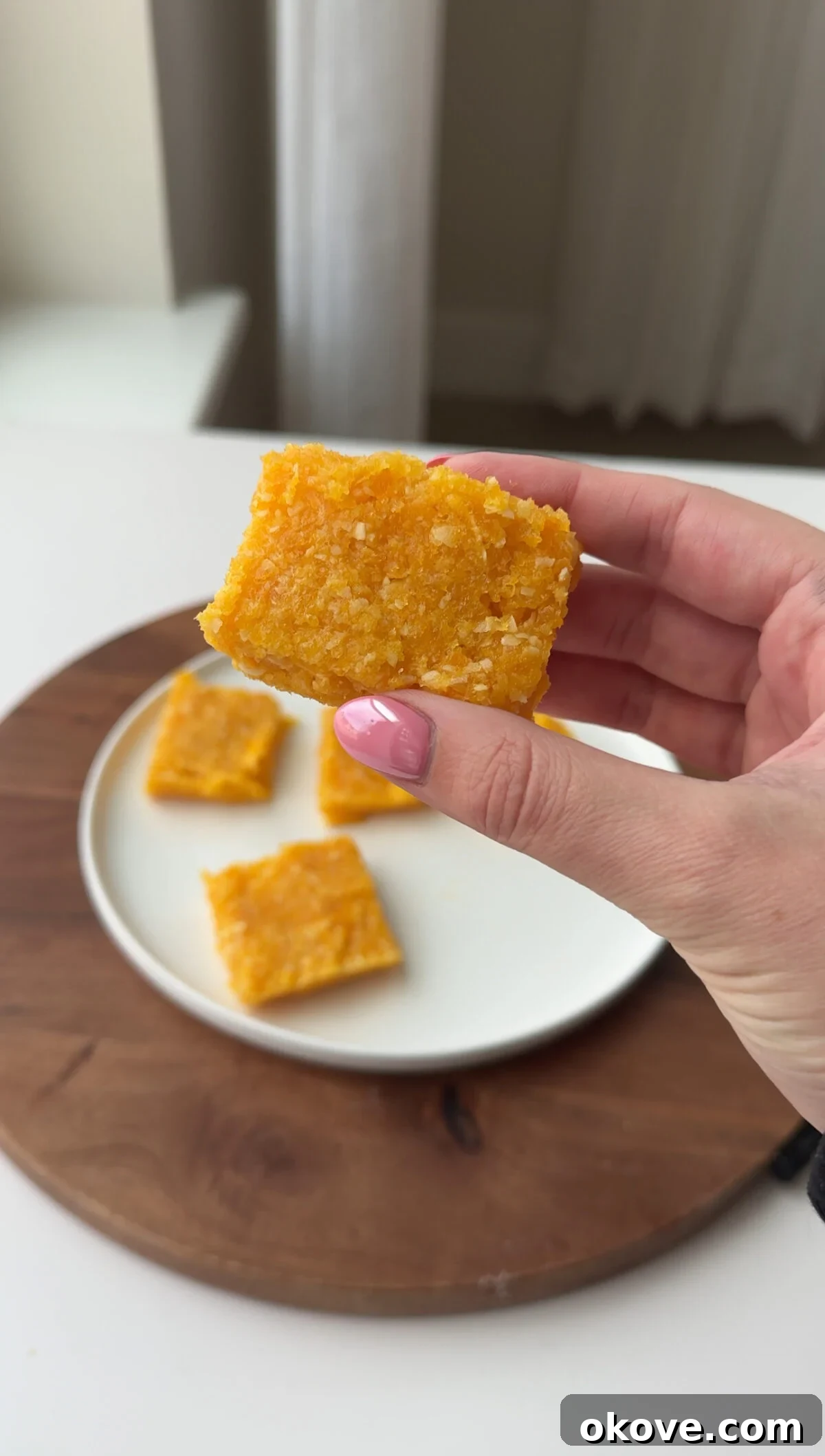 Effortless Apricot Squares 2 A hand holding an easy 2 ingredient apricot bar