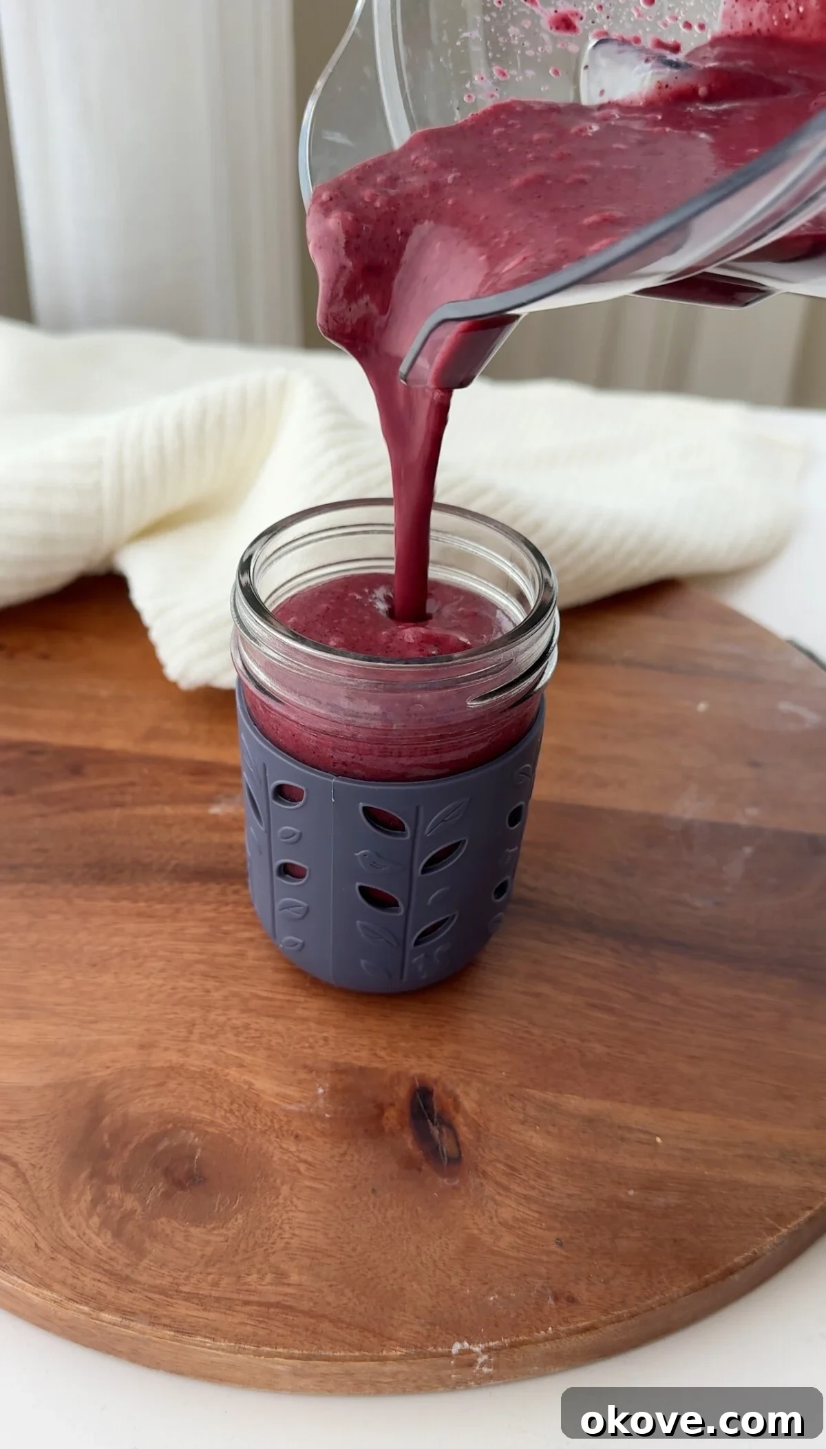 Citrus Berry Bliss 2 Pouring a blueberry citrus smoothie into a cup
