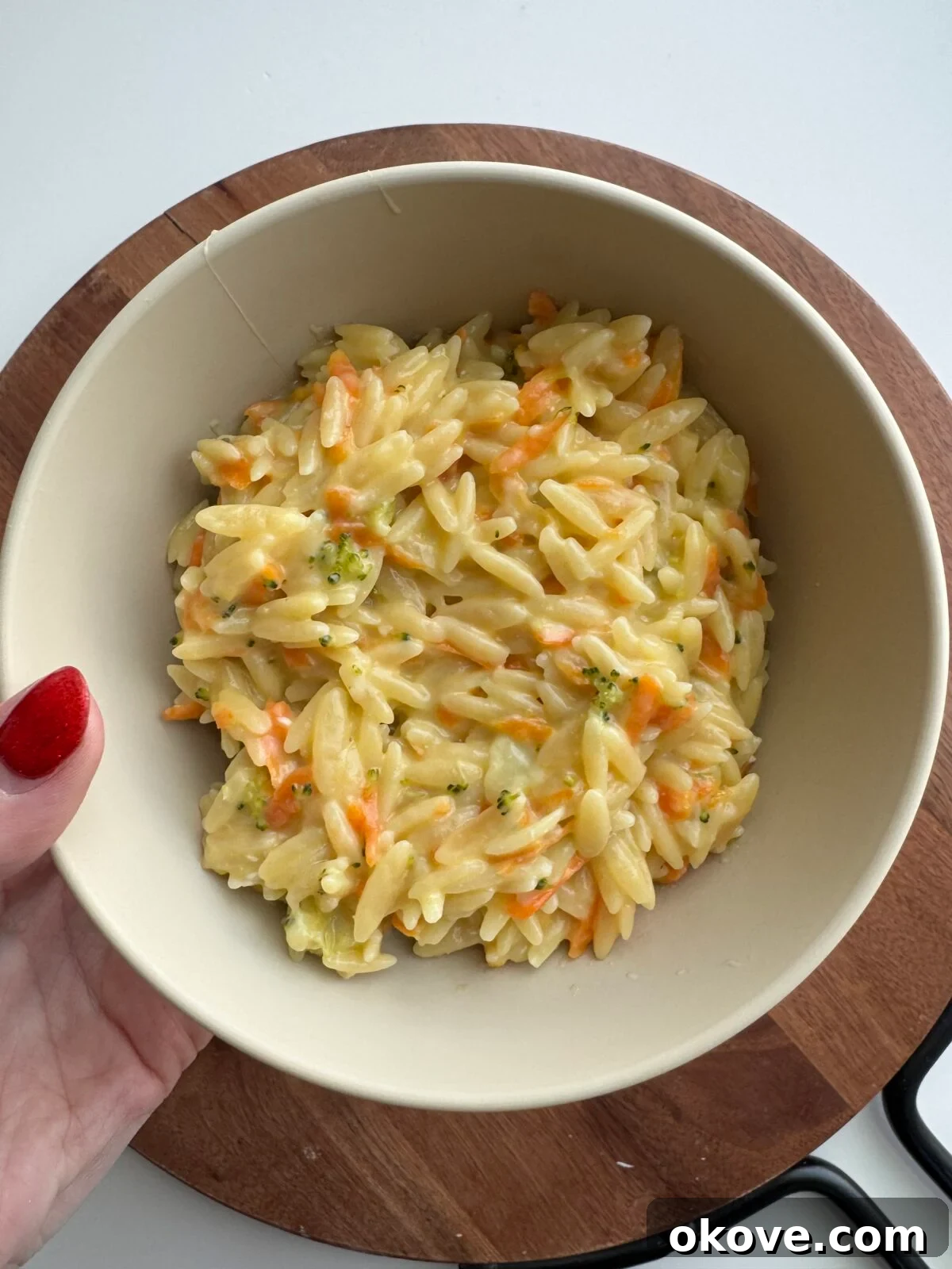 Healthy veggie orzo in a white bowl