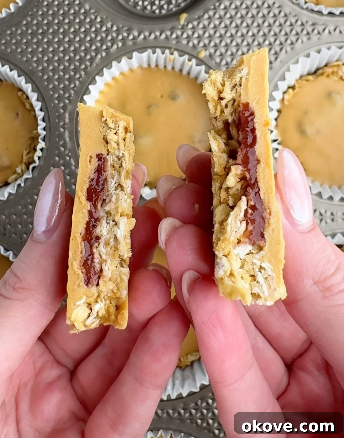 Hands holding two halves of a pb&j oat cup