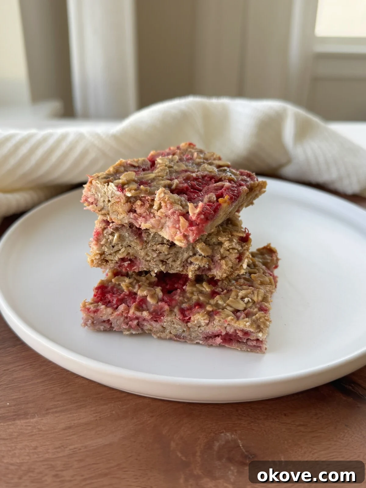 Berry Bliss Oat Bars 2 A stack of three easy raspberry oat bars, perfect for a healthy toddler snack