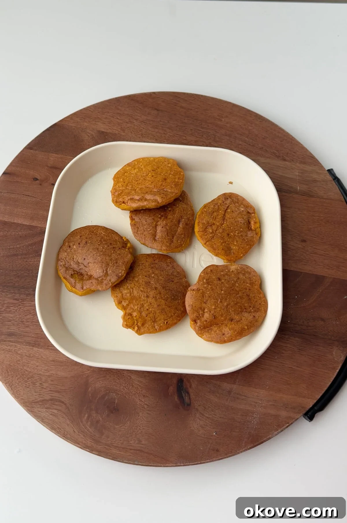 Soft BLW pumpkin pancakes on a white plate, ready for baby-led weaning