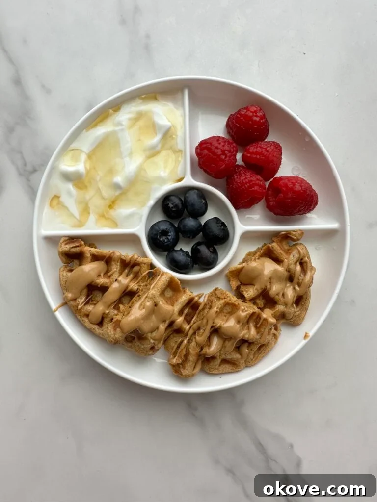 Autumn's Bounty for Little Ones: Pumpkin, Apple, Sweet Potato Recipes 11 Sweet potato waffles on a white plate with strawberries and blueberries