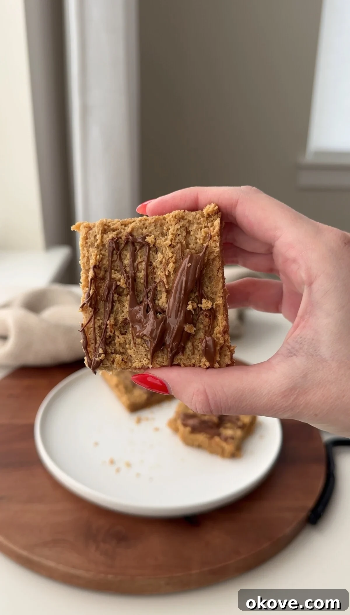 Autumn's Bounty for Little Ones: Pumpkin, Apple, Sweet Potato Recipes 16 A hand holding up a healthy apple oat bar