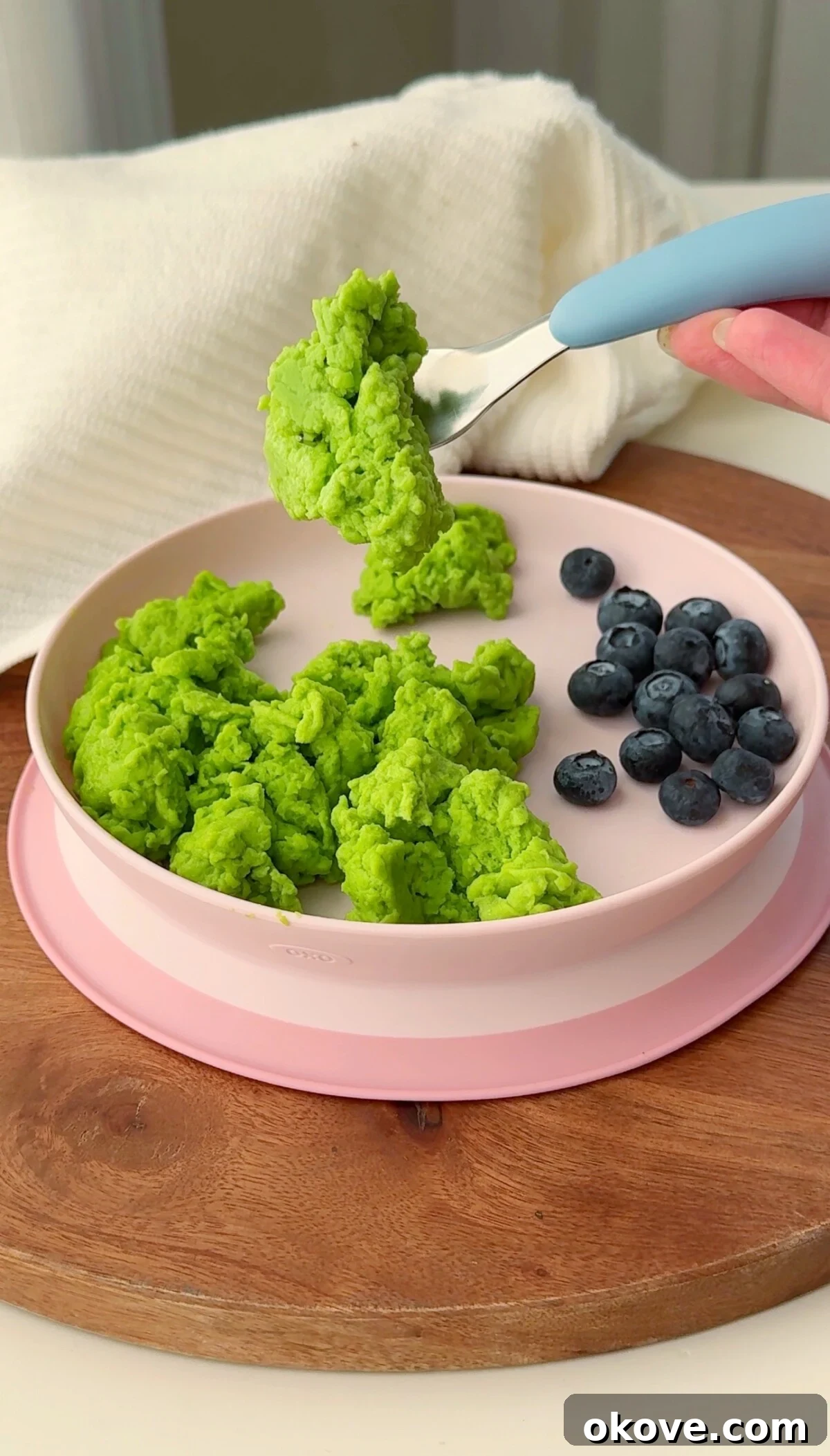 Vibrant green scrambled eggs, known as Hulk Eggs, served in a small bowl, perfect for toddlers.