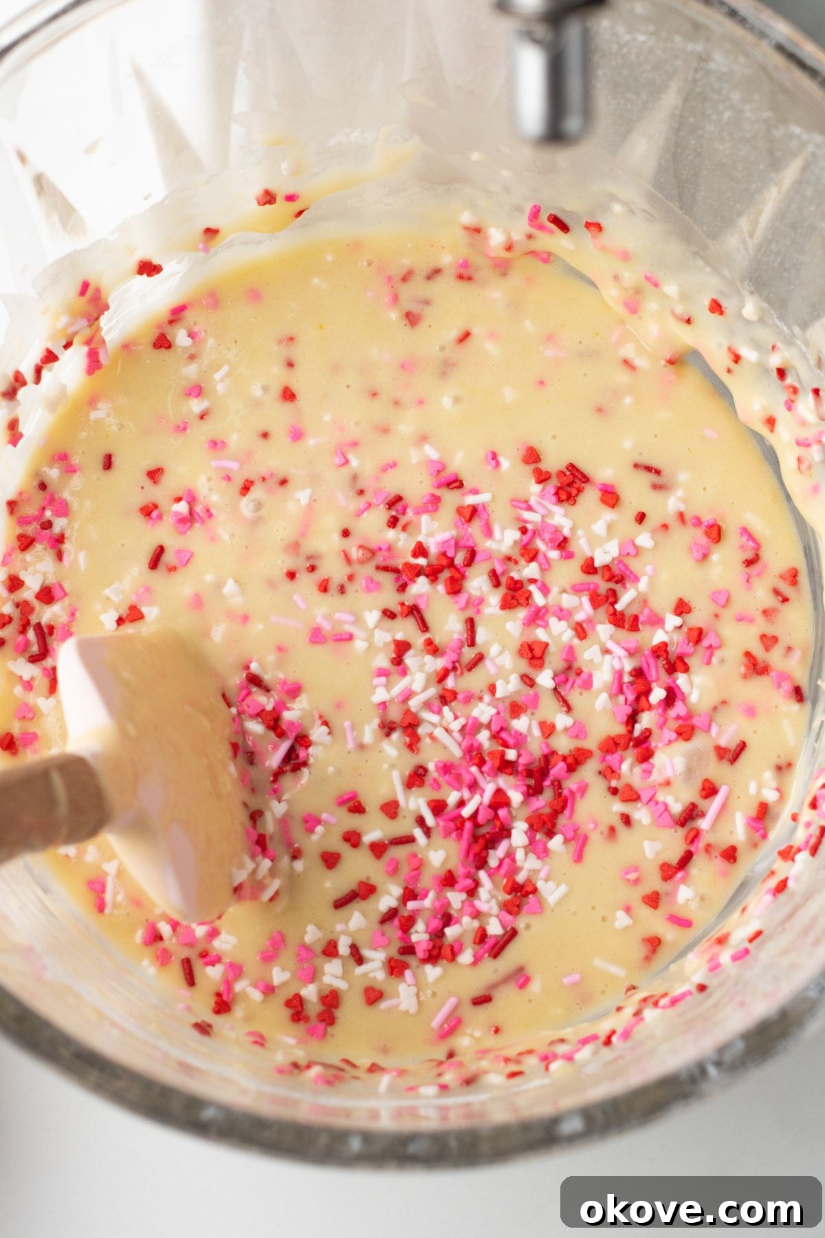 Blushing Sweet Treats 6 Pink sprinkles mixed in the with cupcake batter in mixing bowl.