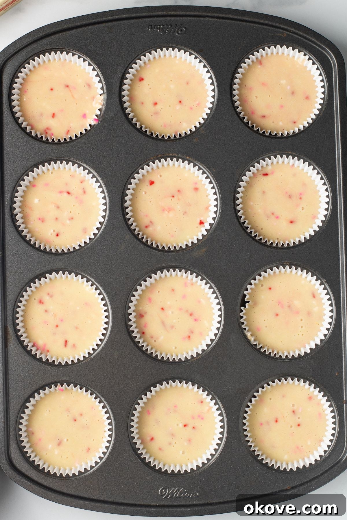 Blushing Sweet Treats 7 Cupcake batter in a muffin tin before baking.