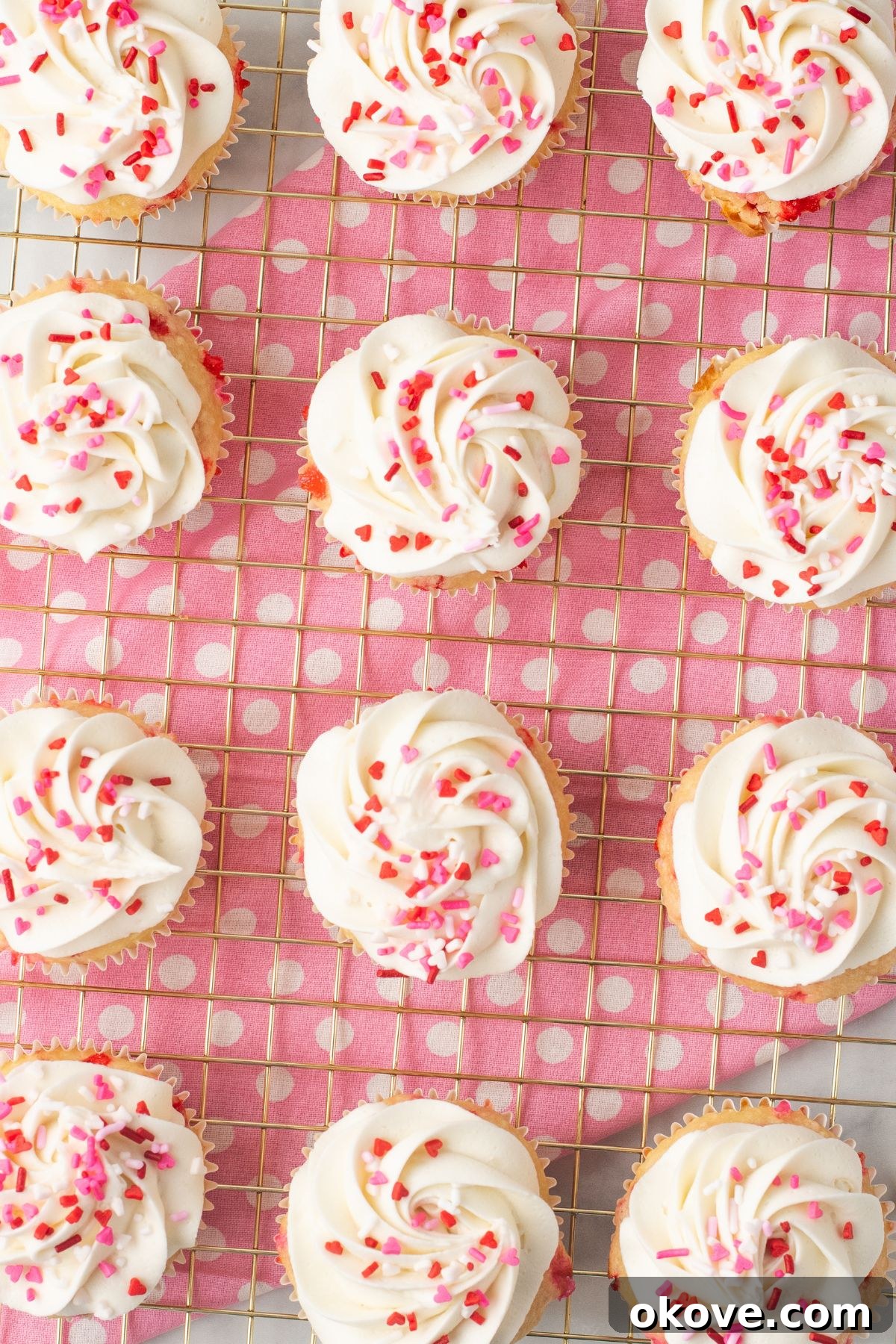 Blushing Sweet Treats 10 Perfectly frosted pink cupcakes, ready to be enjoyed.