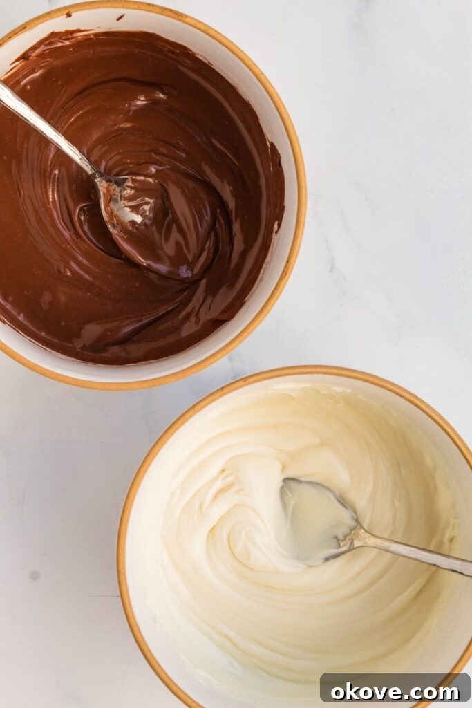 Gourmet Cocoa Melts 4 White and milk chocolate melted in bowls with spoons in them.