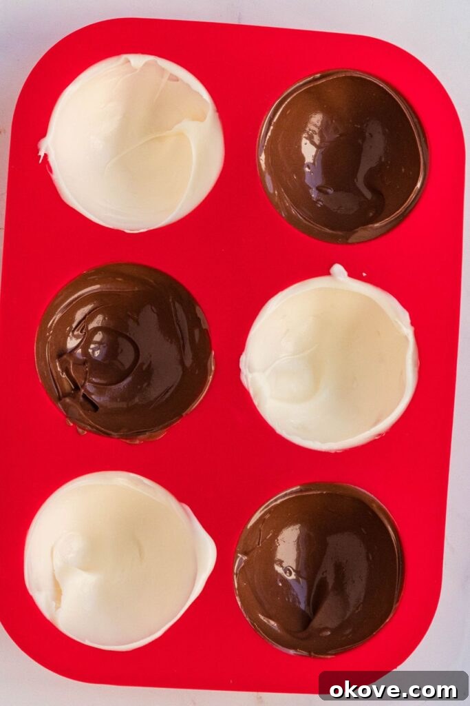 Gourmet Cocoa Melts 5 Melted chocolate in a red silicone mold to make cocoa bombs.
