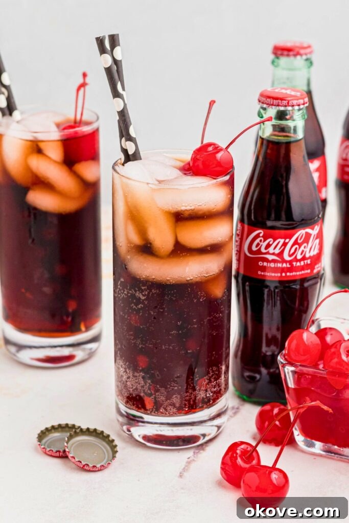 Saddle Up Soda 7 Cola and grenadine mixed a highball glass, topped with cherries and black straws added.