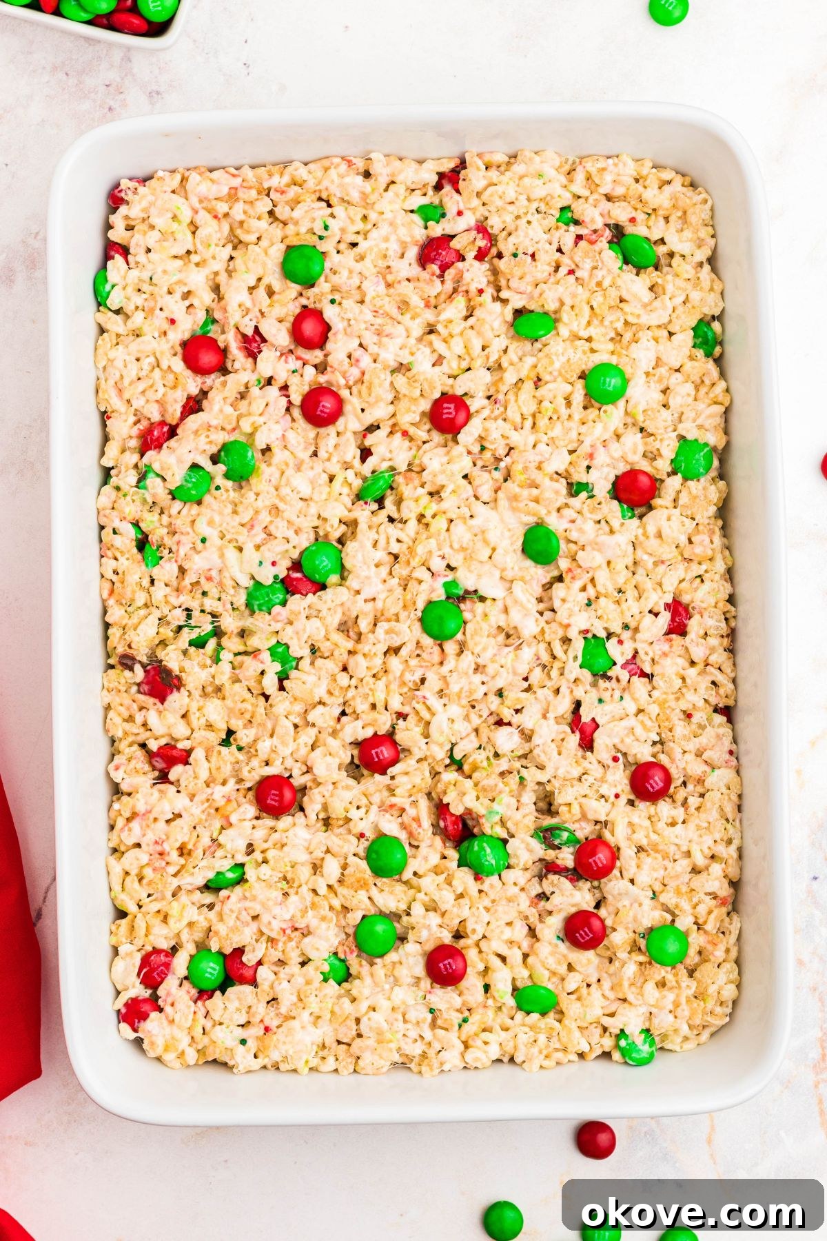 rice krispie treats with red and green chocolate candies mixed in.