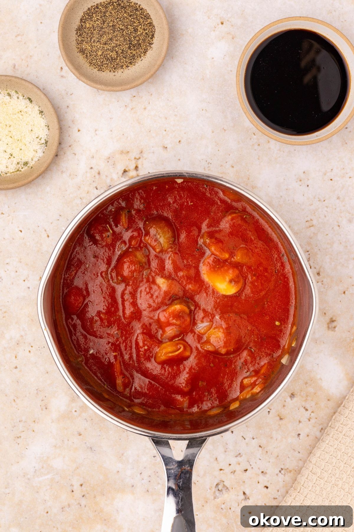 Classic Italian Meatloaf 11 Marinara sauce with mushrooms, onions, and seasonings simmering in a small saucepan.