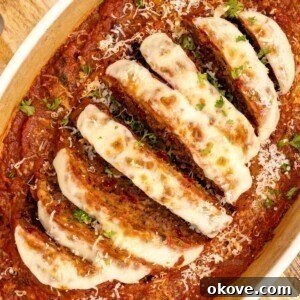 Italian meatloaf in an oval casserole dish, topped with mozzarella cheese and marinara sauce