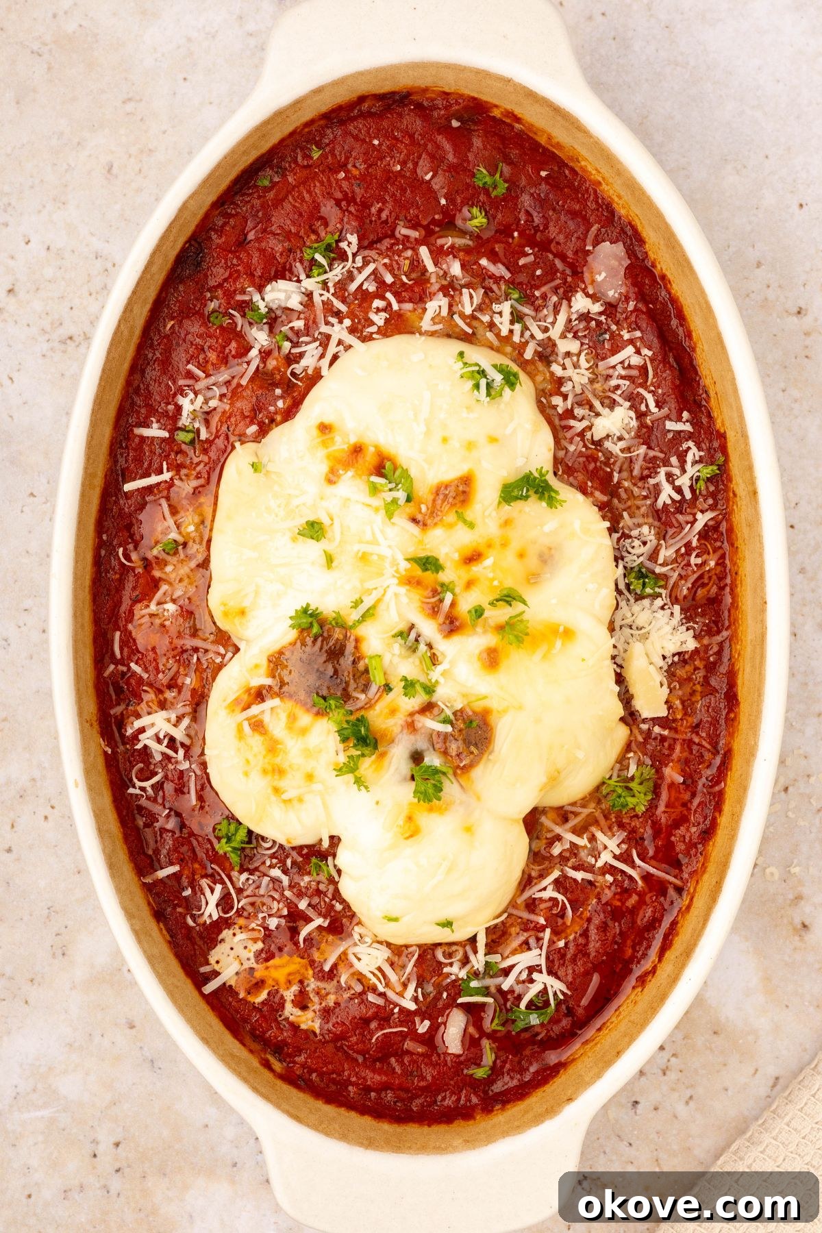Classic Italian Meatloaf 10 Italian meatloaf in an oval casserole dish, generously topped with melted mozzarella cheese and simmering marinara sauce.