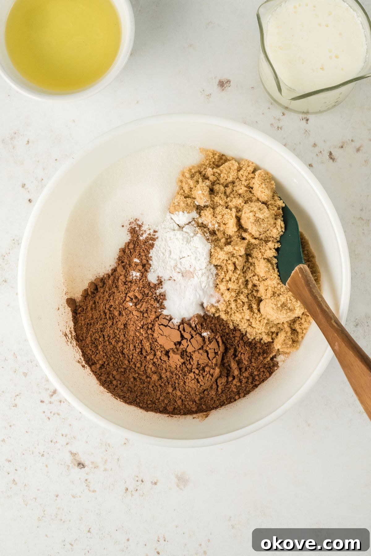 Peanut Butter Chocolate Dream Cake 4 Dry ingredients being mixed in a large bowl, showing the initial stage of cake preparation.