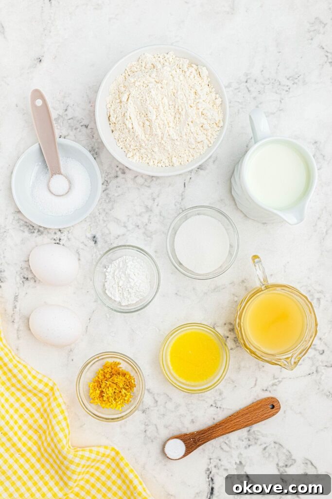 Ingredients measured in small bowls on a white marble table. 