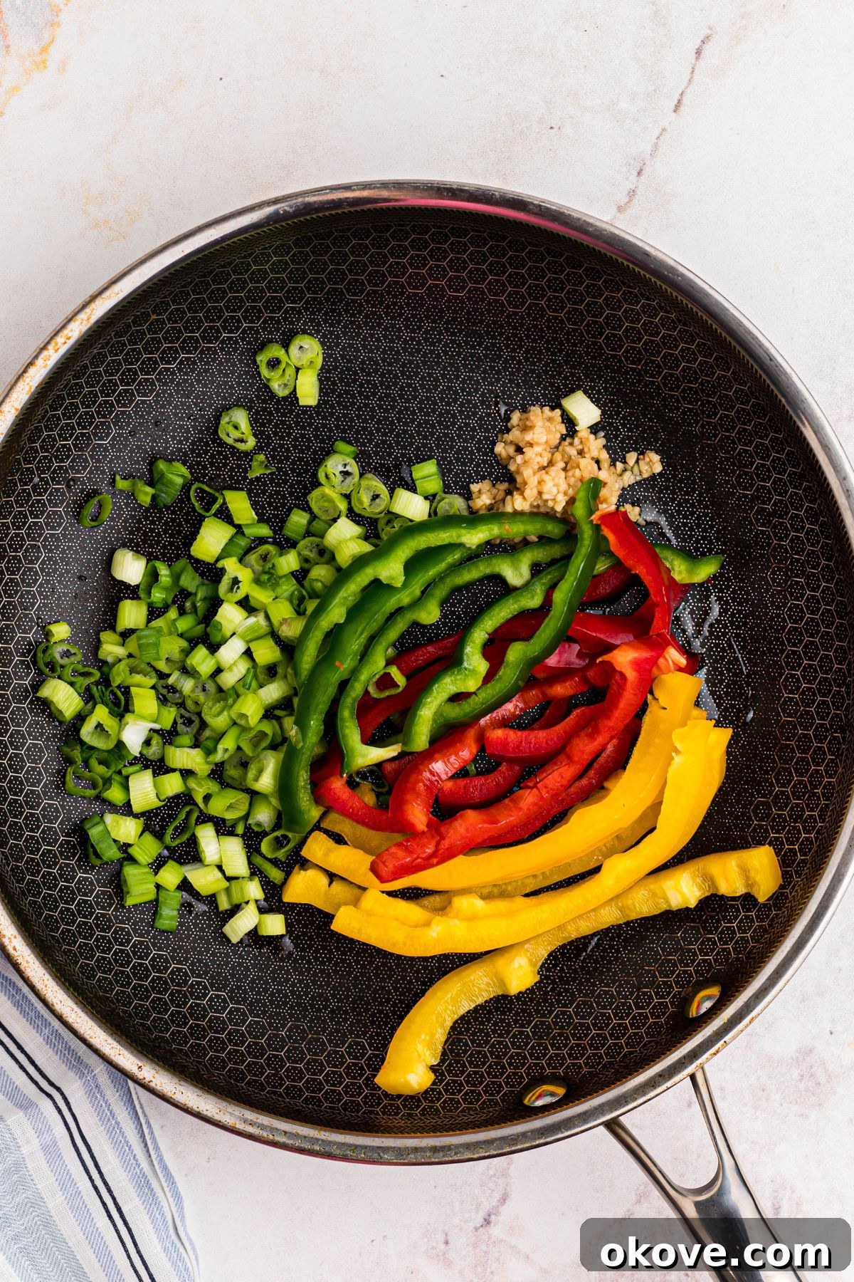Vibrant Jerk Pasta 5 Vibrant bell peppers, green onions, and minced garlic sautéing in a large skillet, creating a fragrant and colorful base for the creamy sauce.