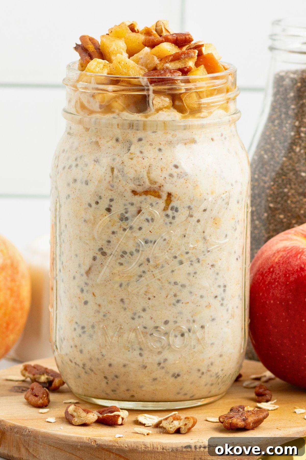Overnight Apple Pie Bliss 2 Creamy yogurt mixed with oats and apple slices in a mason jar making apple pie overnight oats.