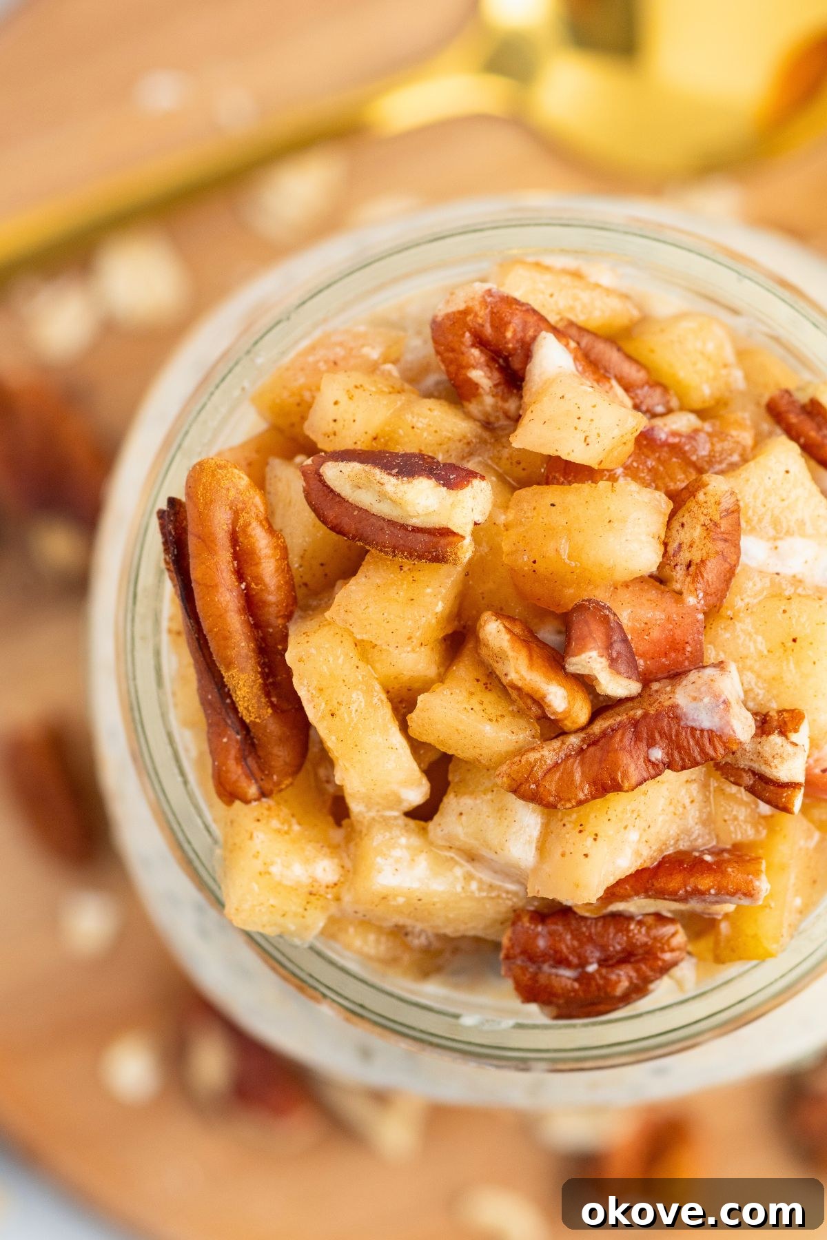 Overnight Apple Pie Bliss 8 Overhead photo of apple pie overnight oats in a mason jar, topped with chopped apples and nuts.