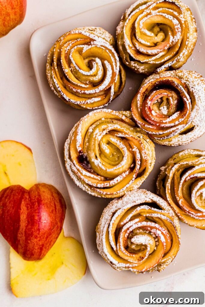 Baked Apple Blooms 2 Baked apple roses on a rectangle plate, topped with powdered sugar.