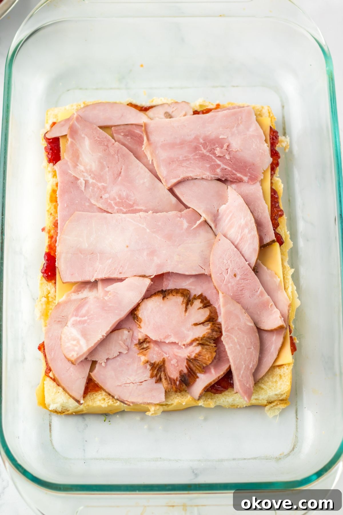 Festive Finger Sandwiches 5 Slices of ham on top of Hawaiian rolls.