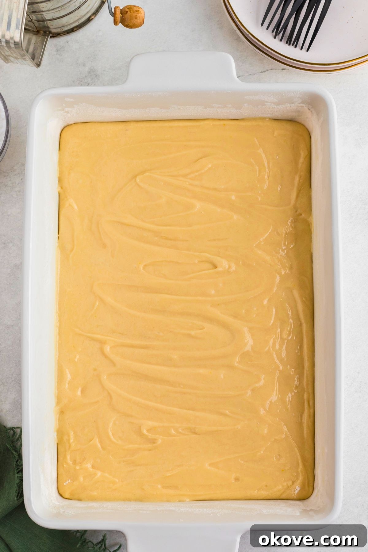 Buttery Bliss Cake 6 Uncooked cake batter spread evenly into a baking dish.