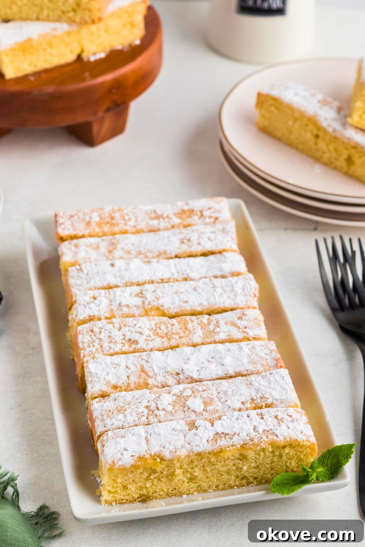 Buttery Bliss Cake 8 Golden buttery cake slices on a rectangle serving platter.