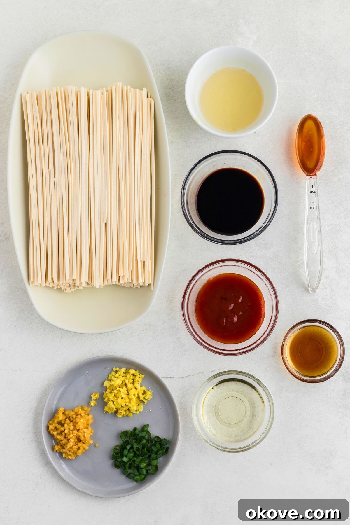 Blazing Noodle Bliss 3 Ingredients needed to make spicy noodles measured on a white marble table.