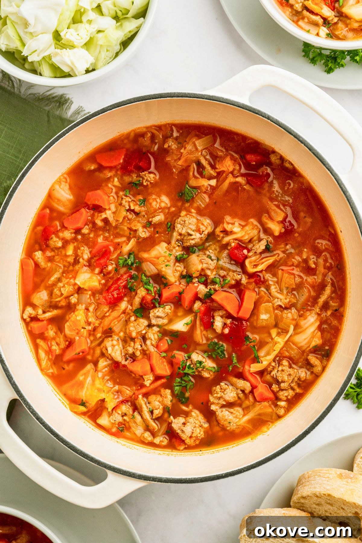 Stuffed Cabbage Soup 2 Cabbage roll soup in a white stock pot topped with chopped parsley. A comforting and hearty one-pot meal.