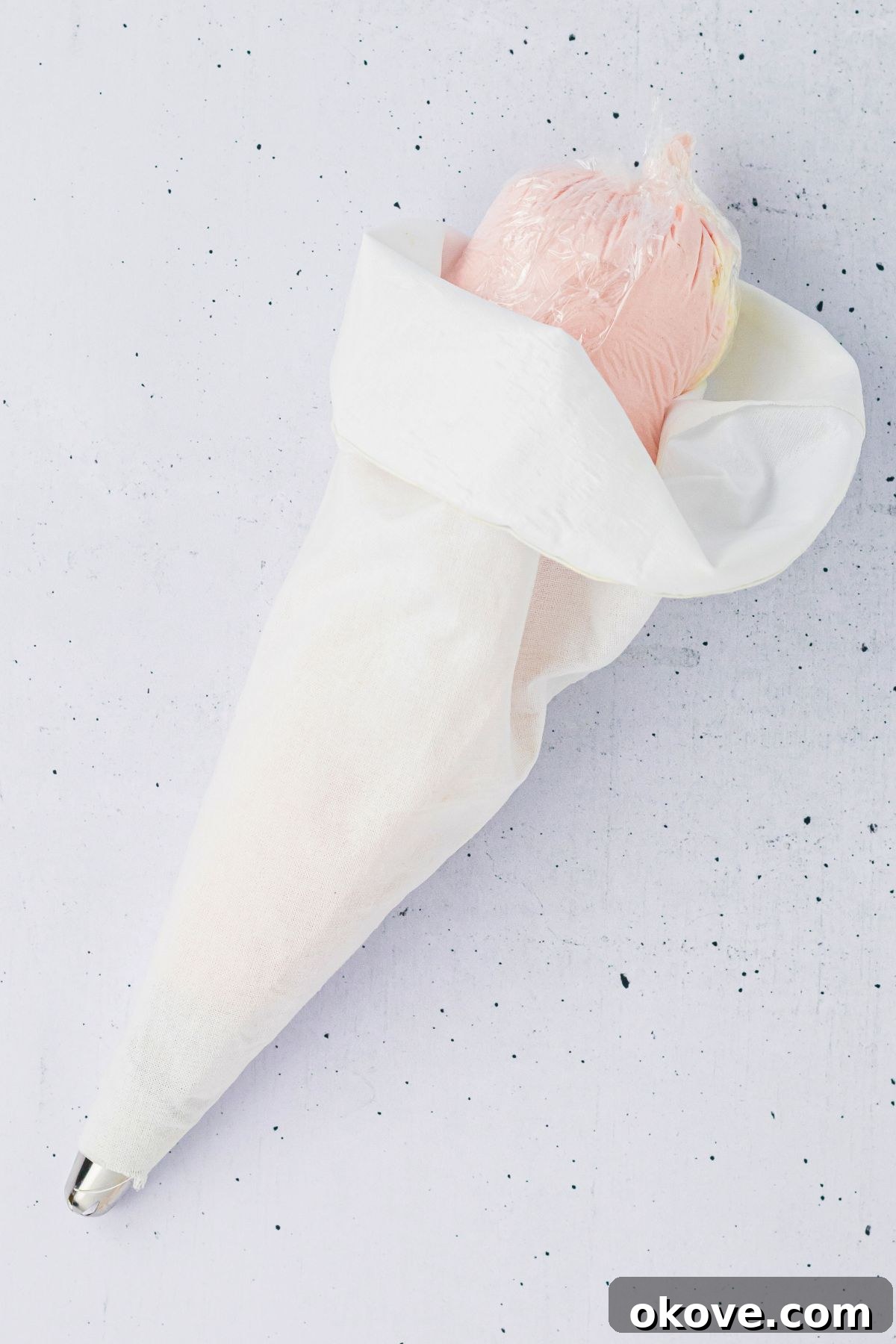 Pink and white frosting, wrapped in plastic wrap, then put into one piping bag. 