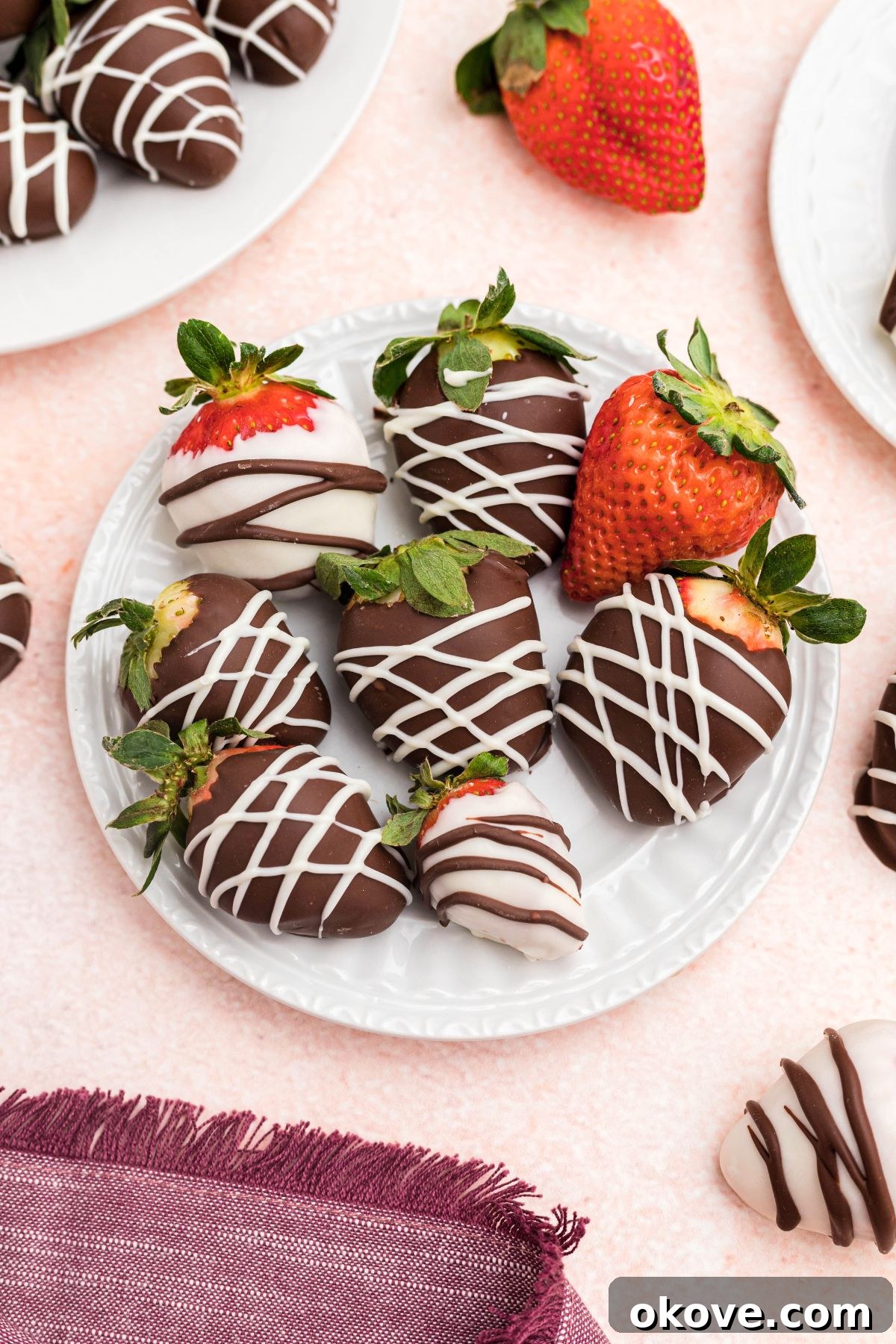 Effortless Chocolate Strawberry Delights 6 Small white appetizer plate with strawberries added to plate.