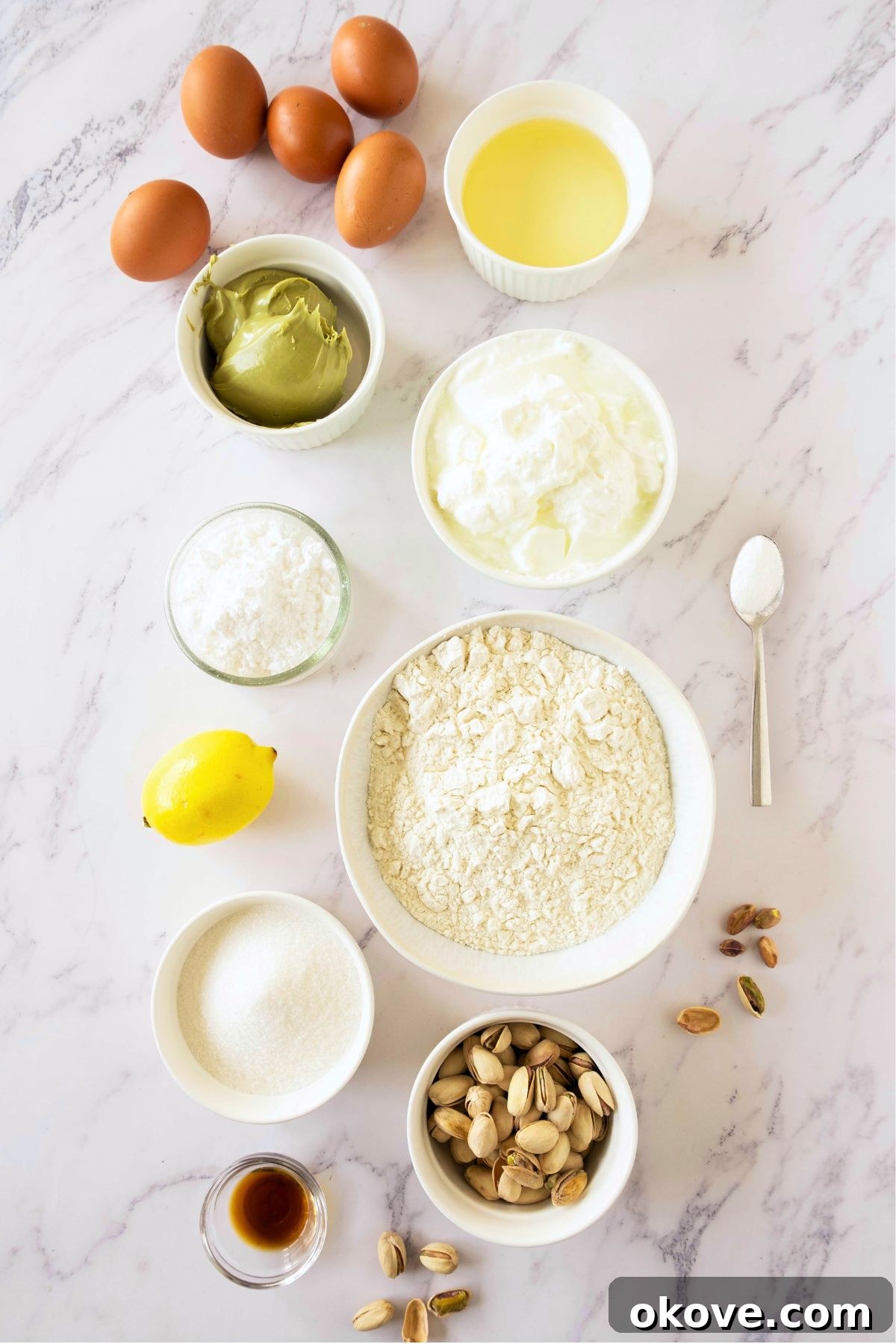 Emerald Pistachio Bundt 3 Ingredients needed to make cake measured out in white bowl on a marble table.