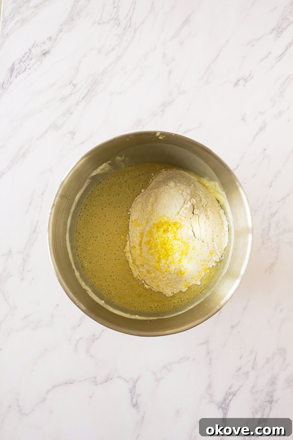 Emerald Pistachio Bundt 4 Ingredients mixed together in a large silver bowl.