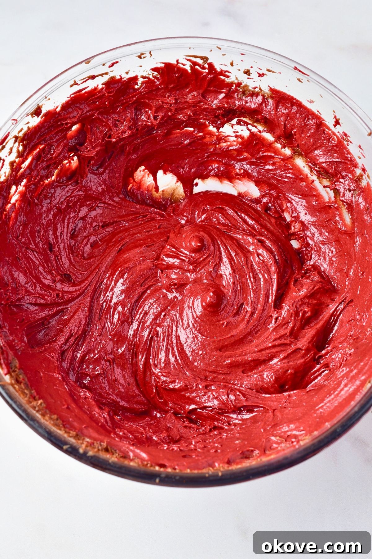 Crimson Velvet Brownies 6 Bright red brownie batter in a clear glass bowl.