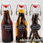 Three bottles of homemade vanilla extract in different stages of infusion with vanilla pods.