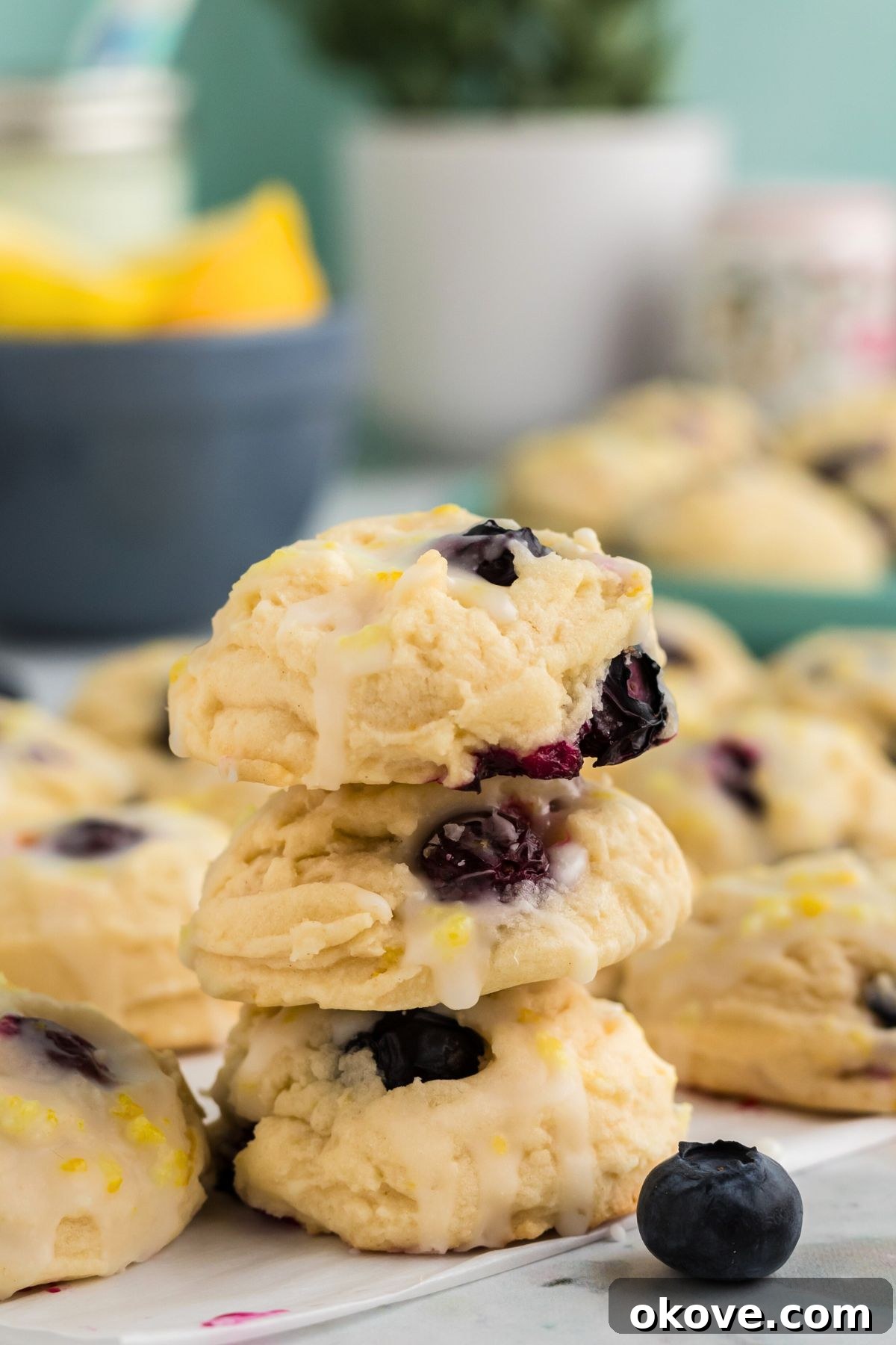 Tangy Blueberry Lemon Delights 11 A stack of golden, perfectly baked lemon blueberry cookies presented on a marble table, inviting and ready to be enjoyed.