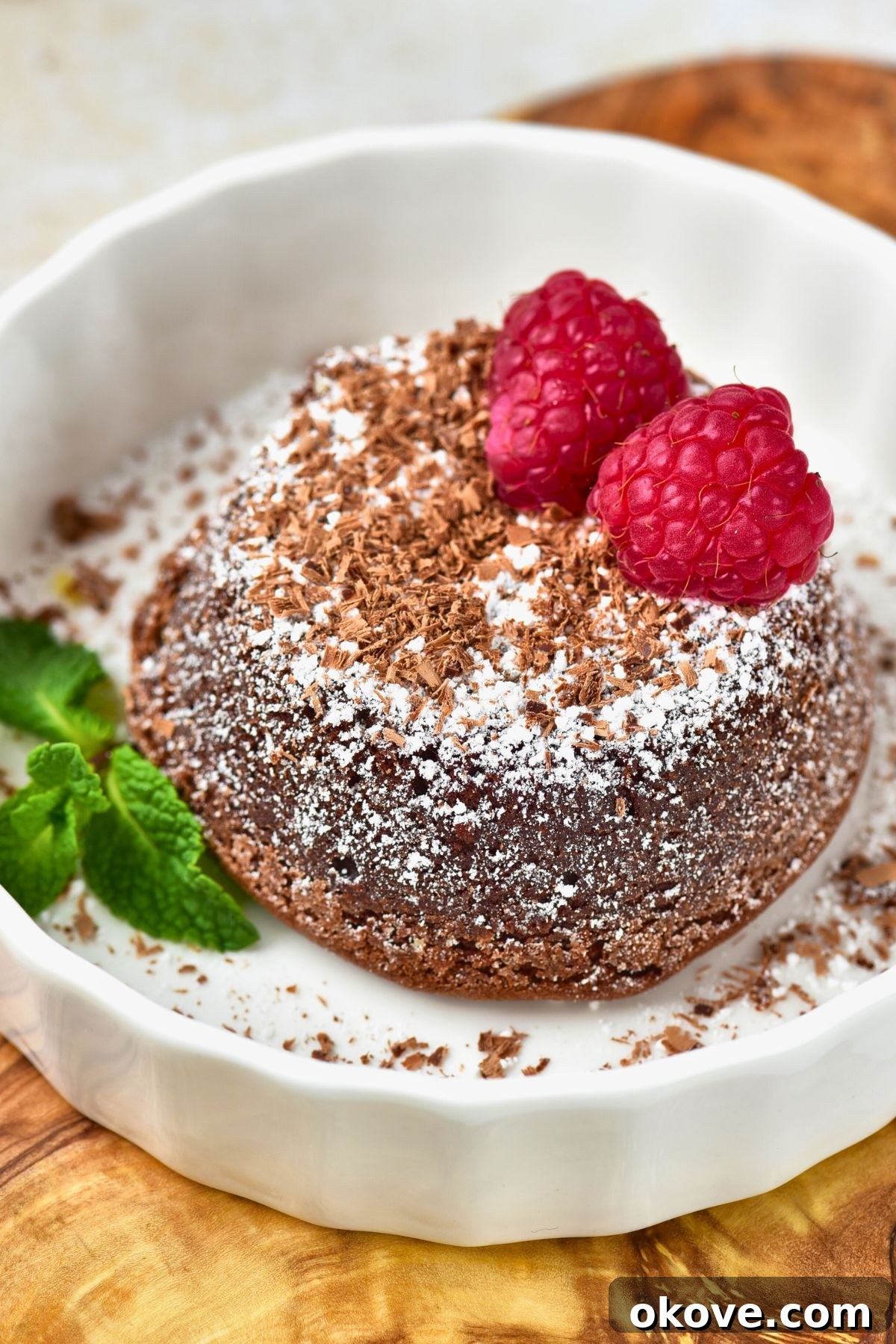 Molten Chocolate Dream 8 A freshly unmolded chocolate lava cake on a white plate, before being cut, showing its perfect dome and inviting texture.