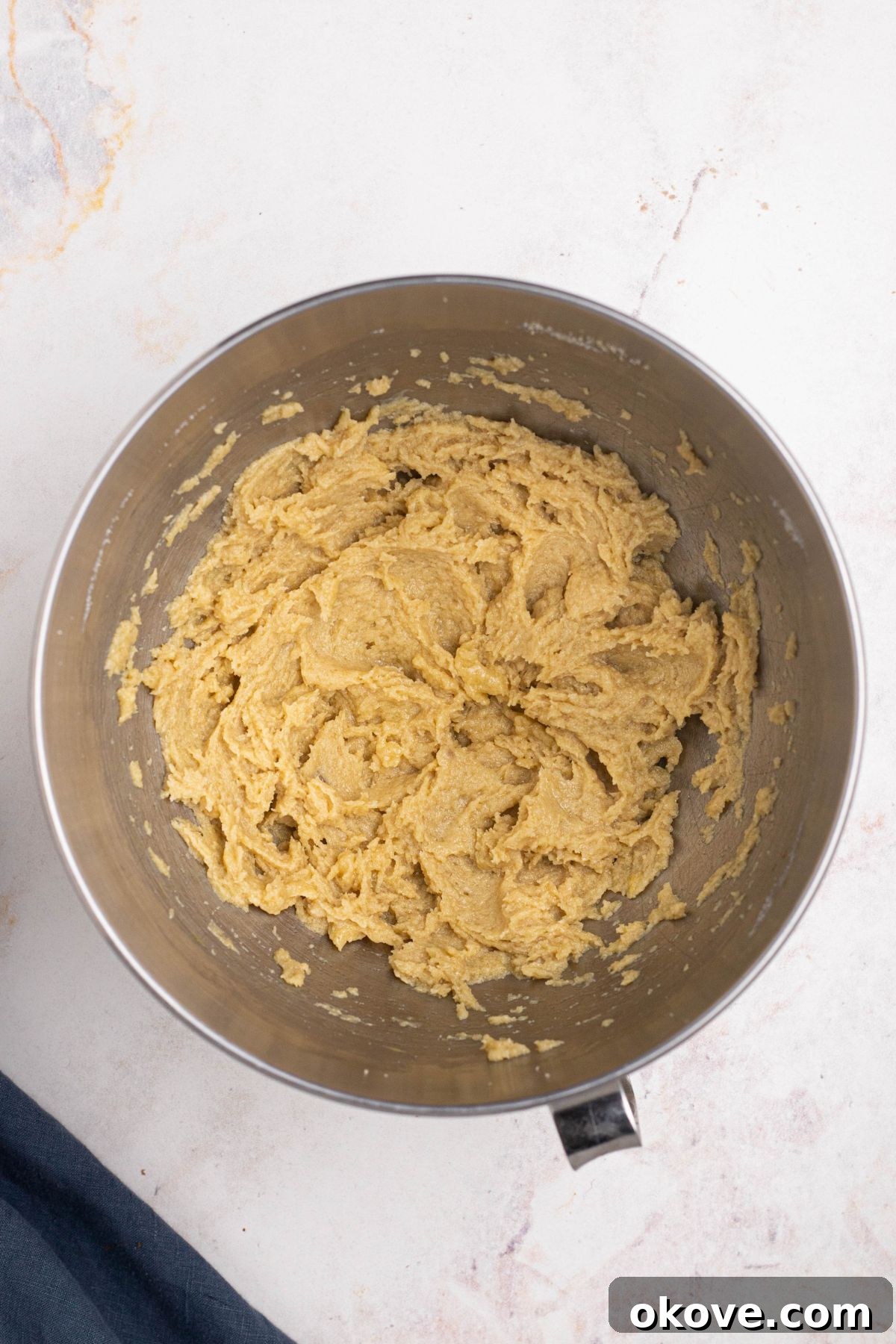 Luscious Double Chocolate Chip Cookies 5 Creamed butter and sugars in a mixing bowl before cocoa powder and chocolate chips are added.