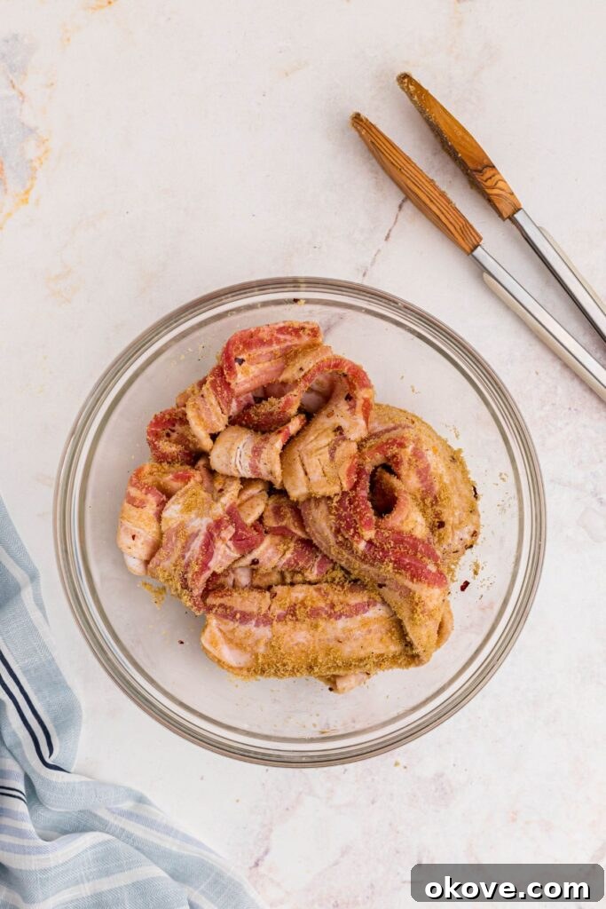 Decadent Caramelized Bacon 4 Bacon tossed with brown sugar and spices in a large glass bowl.