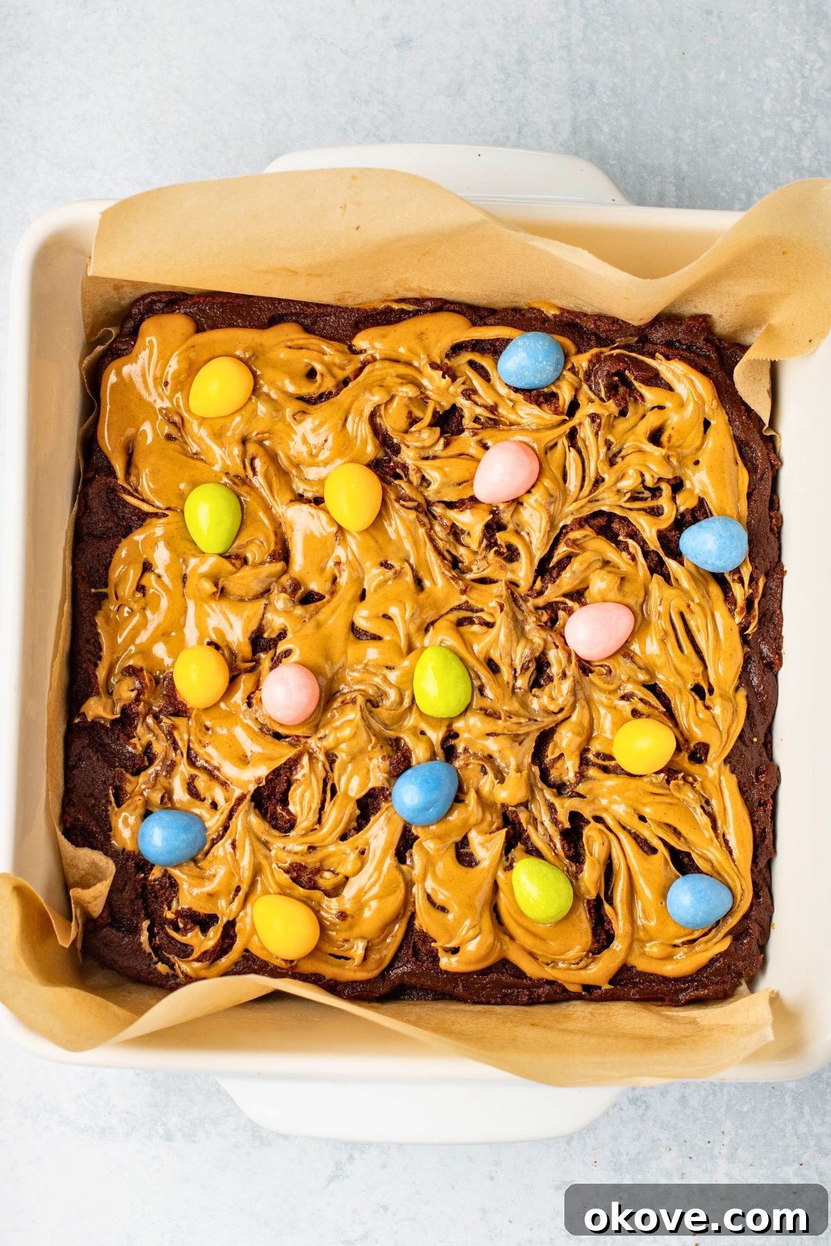 Brownie batter topped with peanut butter batter, then topped with candy eggs.
