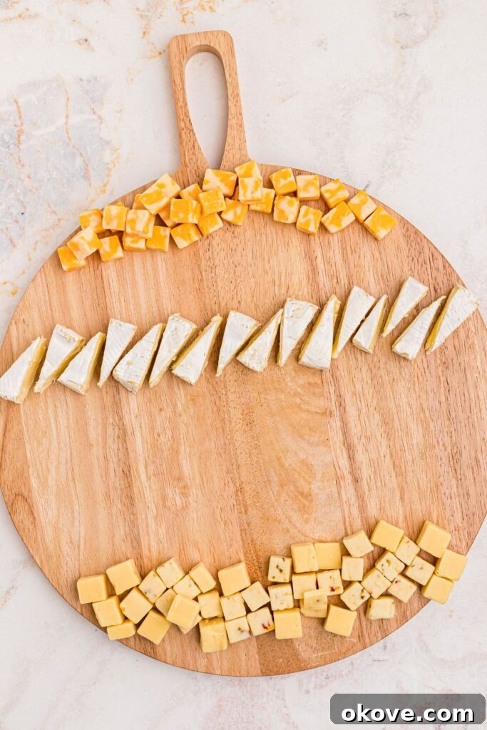 An inviting assortment of various cheeses spread artfully on a charcuterie board, ready for holiday guests.