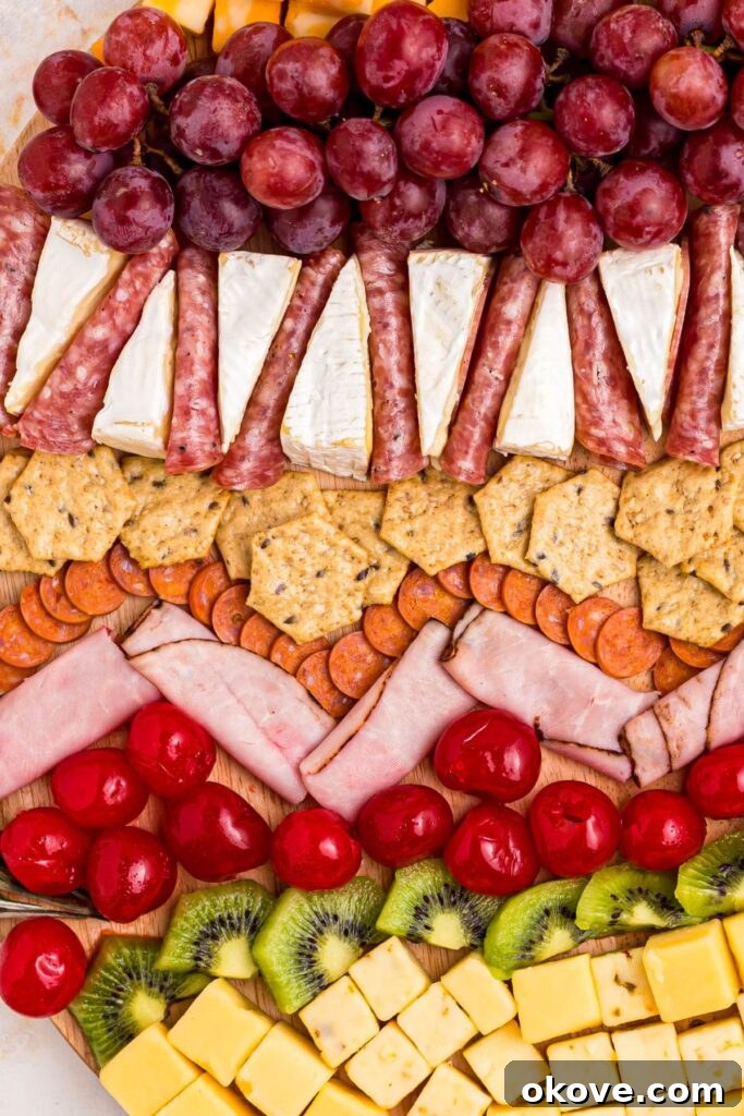 A vibrant and playful Christmas charcuterie board, filled with a colorful array of fruits, meats, and cheeses, perfect for festive gatherings.