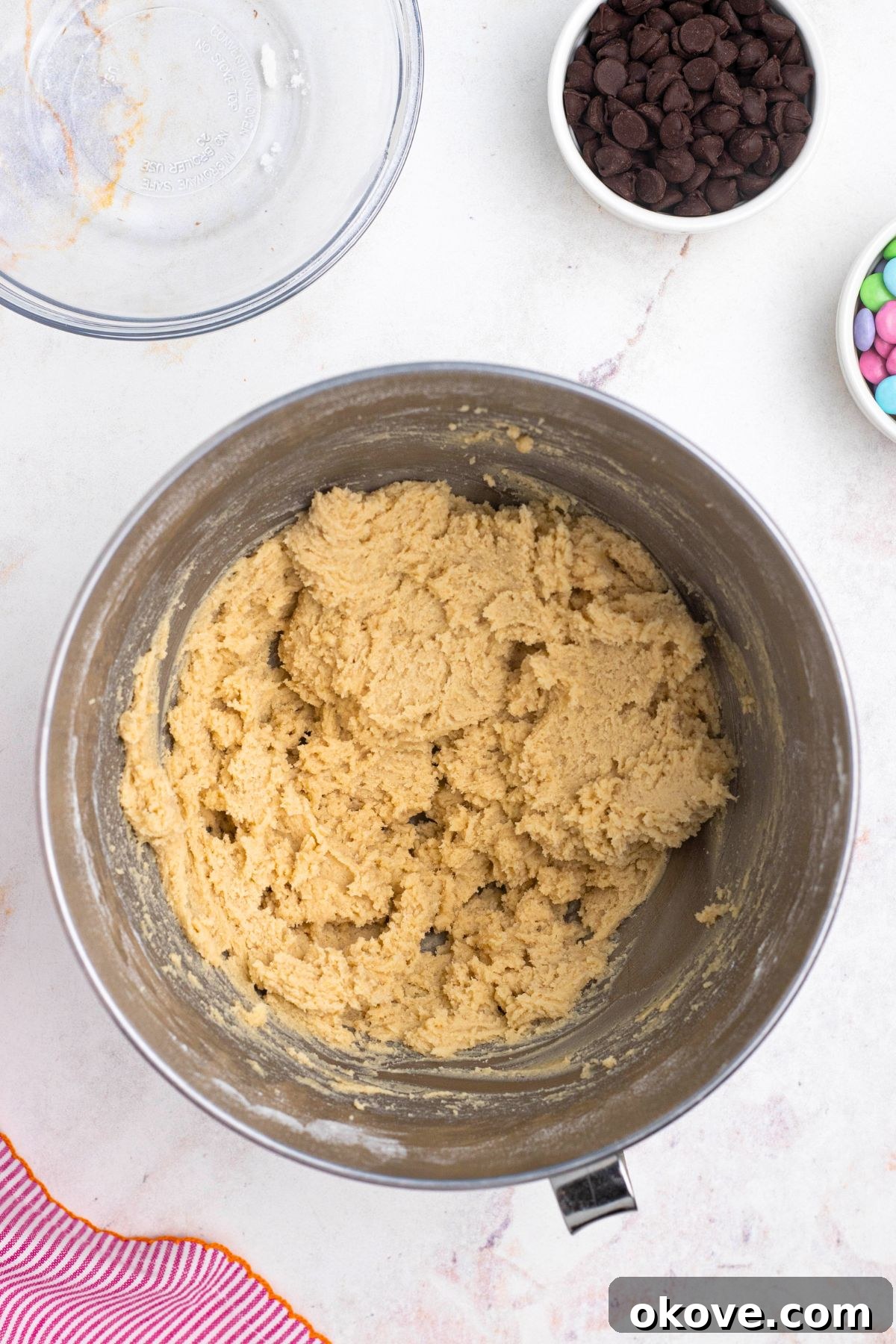 Soft cookie dough mixed in together in a mixing bowl.