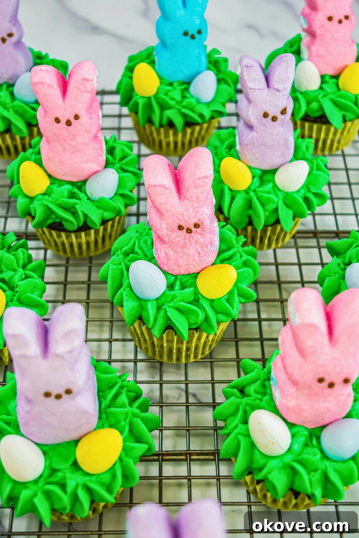 Colorful Peeps Cupcake Delights 9 A stunning display of decorated Peeps cupcakes featuring pastel bunnies on a elegant cake stand, perfect for an Easter celebration.