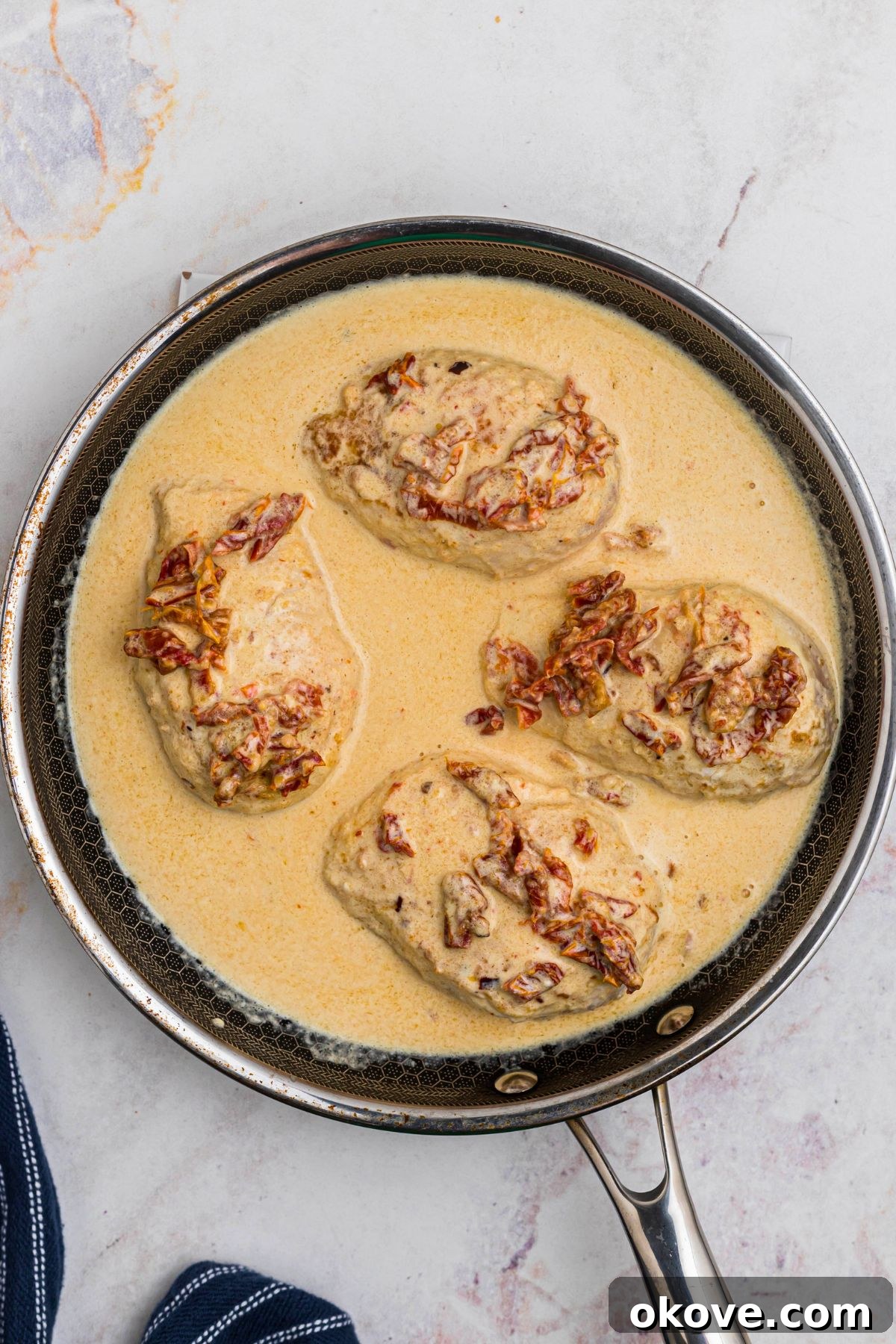 Say Yes Chicken 7 All ingredients combined in the skillet, with seared chicken breasts simmering in the rich, creamy sauce before reaching final doneness.