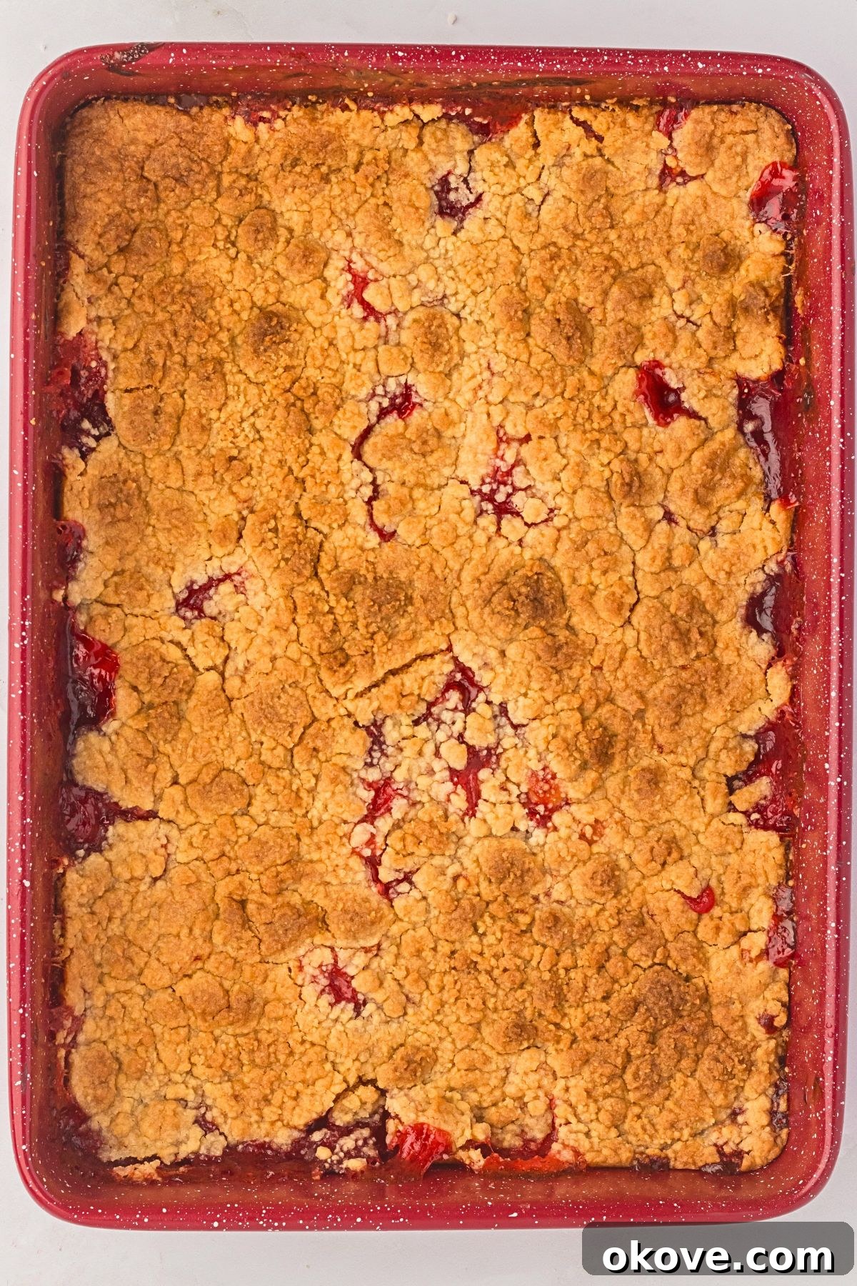 Effortless Strawberry Delight 7 A perfectly baked, golden and bubbly strawberry dump cake in a glass baking pan, fresh from the oven.